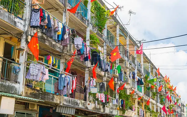 Photo of Old apartment building decorated by Vietnam national flags in th