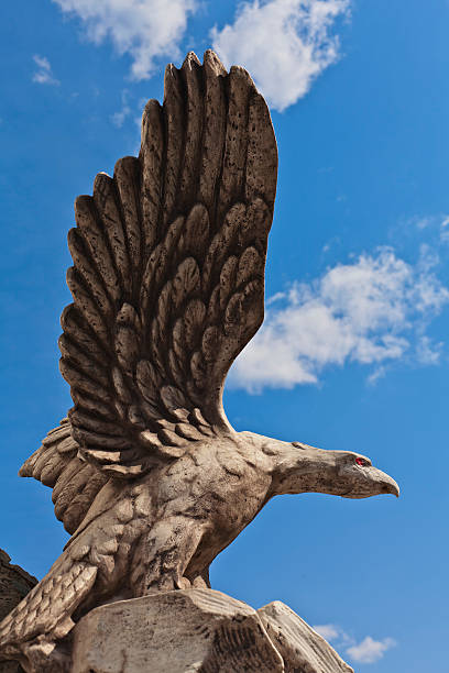 istock stone statue of a bird eagle on a background of blue sky 494346745