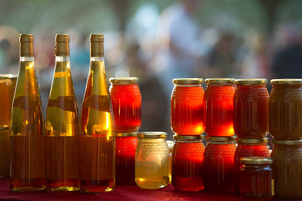 Olive Oil in different glass bottles in a row for sale on market.