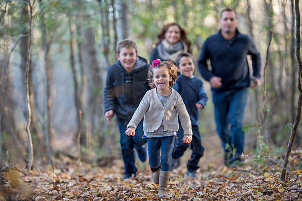 istock Family Playing Tag in the Woods 494348256