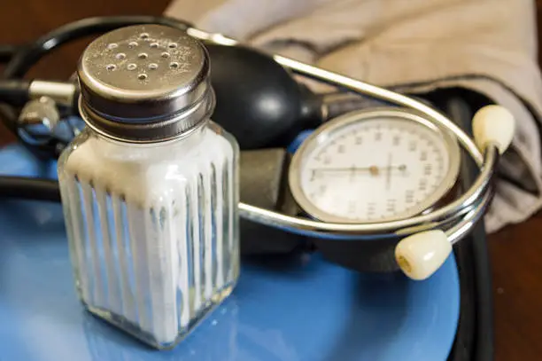 salt shaker and blood pressure gauge on plate