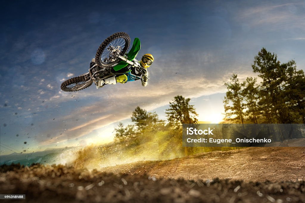 Dirt bike rider is flying high Dirt bike rider is flying high in evening Motorcycle Stock Photo