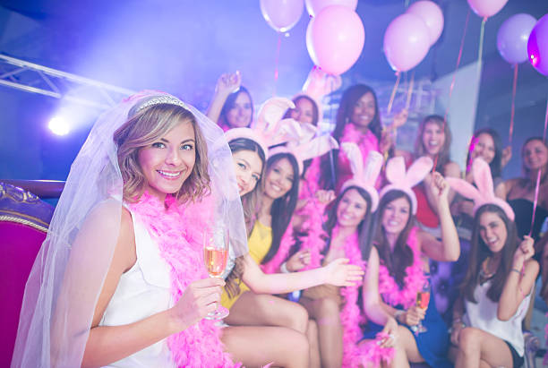Bride having fun on her bachelorette party Bride having fun on her bachelorette party at a nightclub and holding a glass of champagne bachelorette party stock pictures, royalty-free photos & images