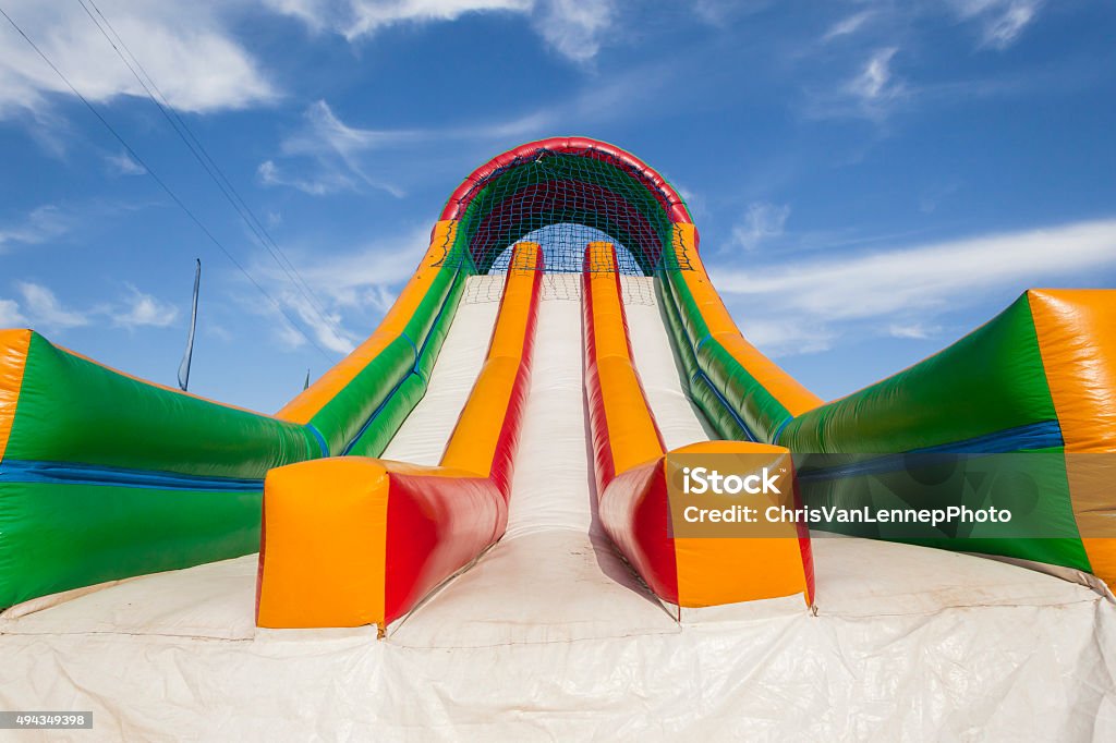 Slide Playground Apparatus Striking canvas colors closeup of playground air slide apparatus. Bouncing Stock Photo