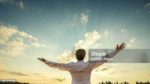 Successful Man Standing With His Arms Spread Towards Majestic Sky Stock Photo - Download Image Now
