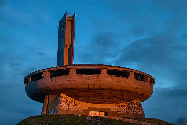 Buzlidzha - socialistic monument in Hadzhi Dimitar peak, Bulgaria. Build in 1981 by the socialistic party in Bulgaria. UFO dish look a like. Illuminated in red by the sunrise.