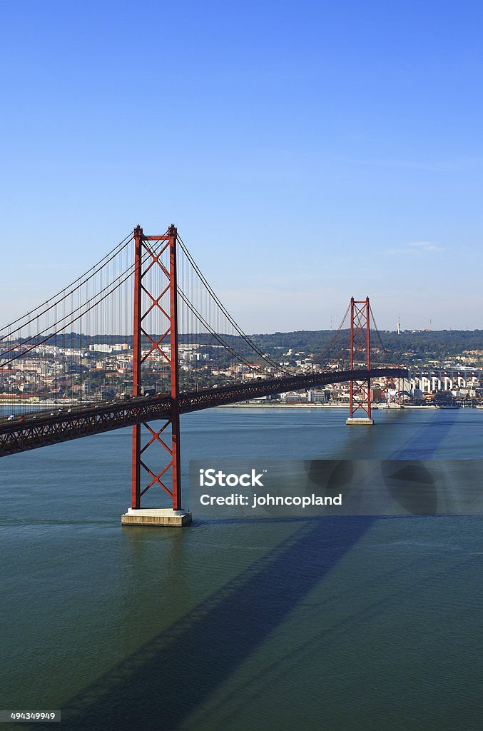 Suspension bridge, Lisbon, Portugal. "Ponte 25 do Abril" - "25th of April" suspension bridge spanning the Tagus "Tejo" River - named after the date of the revolution. Viewed from the Cristo Rei statue in Almada on the southern margin of the river. Setubal District, Portugal. Commercial Dock Stock Photo