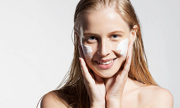 istock Girl put the cream on the face 494350364