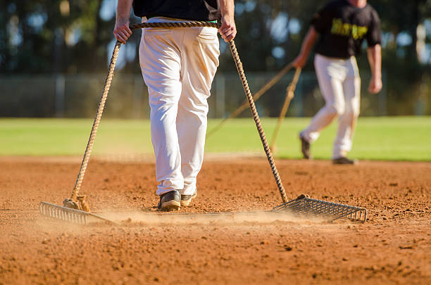 Preparing baseball field Two baseball are players grooming a baseball field baseball pitcher baseball player baseball diamond stock pictures, royalty-free photos & images