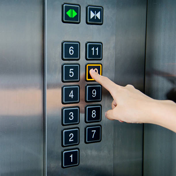 женщина в лифте - elevator push button control panel moving up стоковые фото и изображения