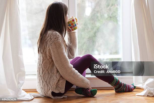 Enjoying Tea By The Window Stock Photo - Download Image Now - Curtain, Heat - Temperature, Winter