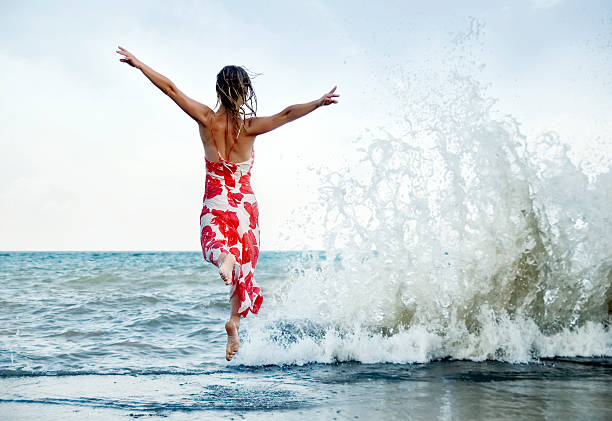 istock Woman jumping on the beach 494354090