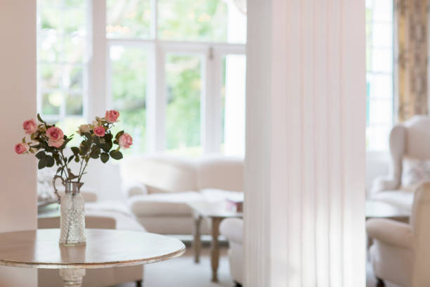Sofa in neutral tones with flowers on a coffee table