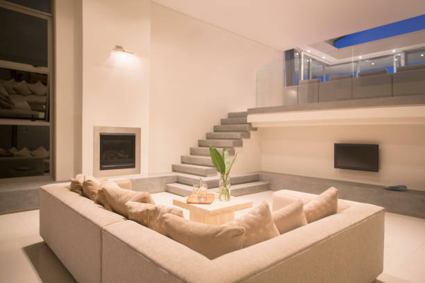 istock Modern living room with balcony illuminated at night 494358369