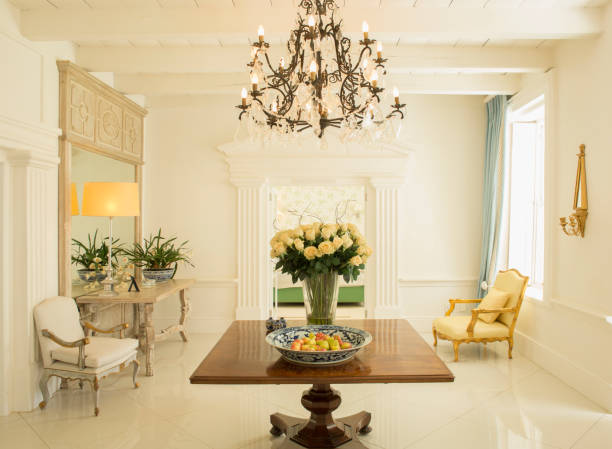 istock Chandelier over rose bouquet on table in luxury foyer 494358421