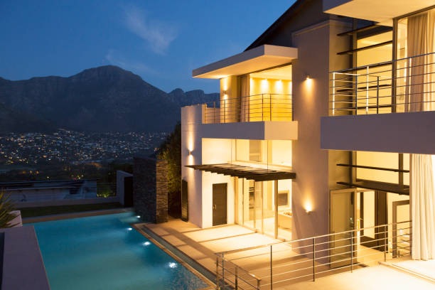 istock Modern house with swimming pool illuminated at night 494358507