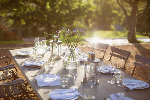 istock Bouquet and place settings on tranquil patio table 494358533