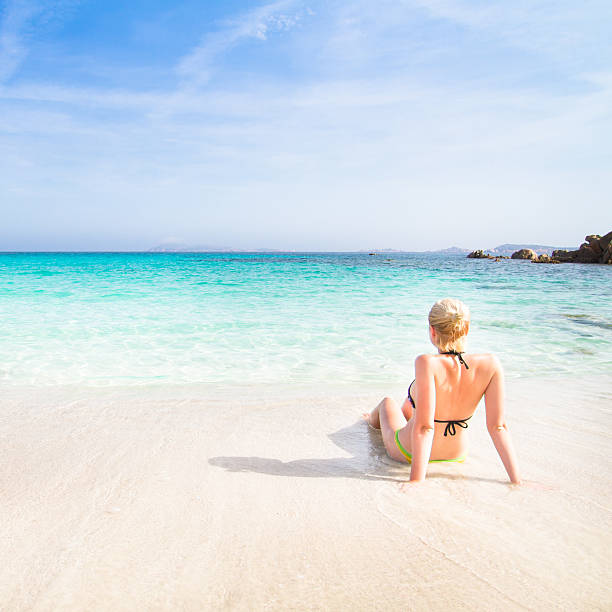 istock woman relaxing on the beach. 494378074