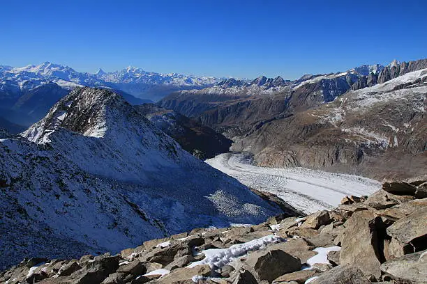 Aletsch Glacier and distant view of the Matterhorn, Weisshorn and other high mountains of the Swiss Alps.