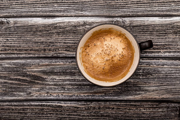 istock Cup of coffee on wooden background, top view 494378466