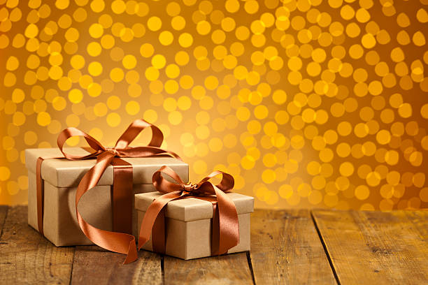 istock Two gift boxes against golden bokeh lights 494380908