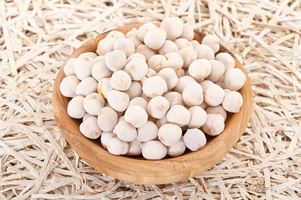 white roasted chickpeas in a wood bowl stock photo