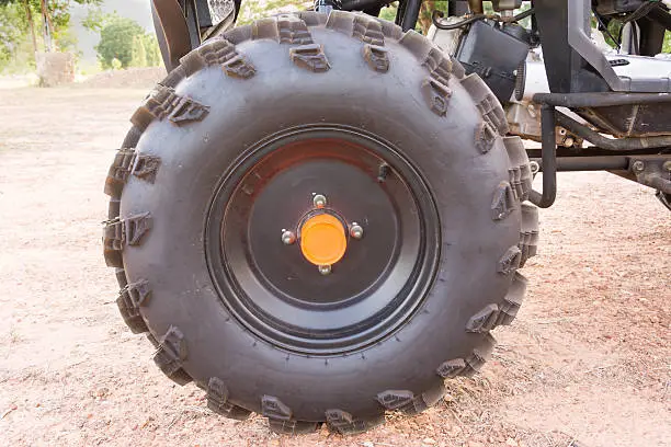 wheel of ATV stand on ground