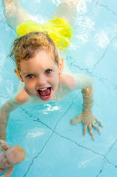 istock Cheerful kid in the swimming pool water 494382140
