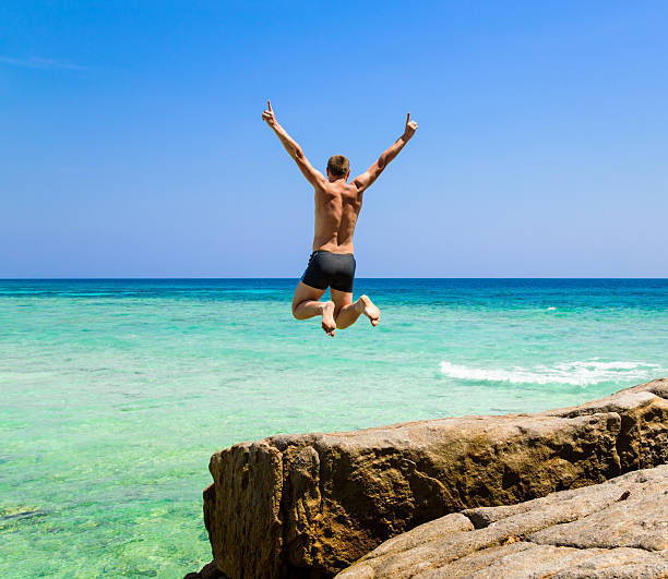 istock Man jumping in the sea 494386224