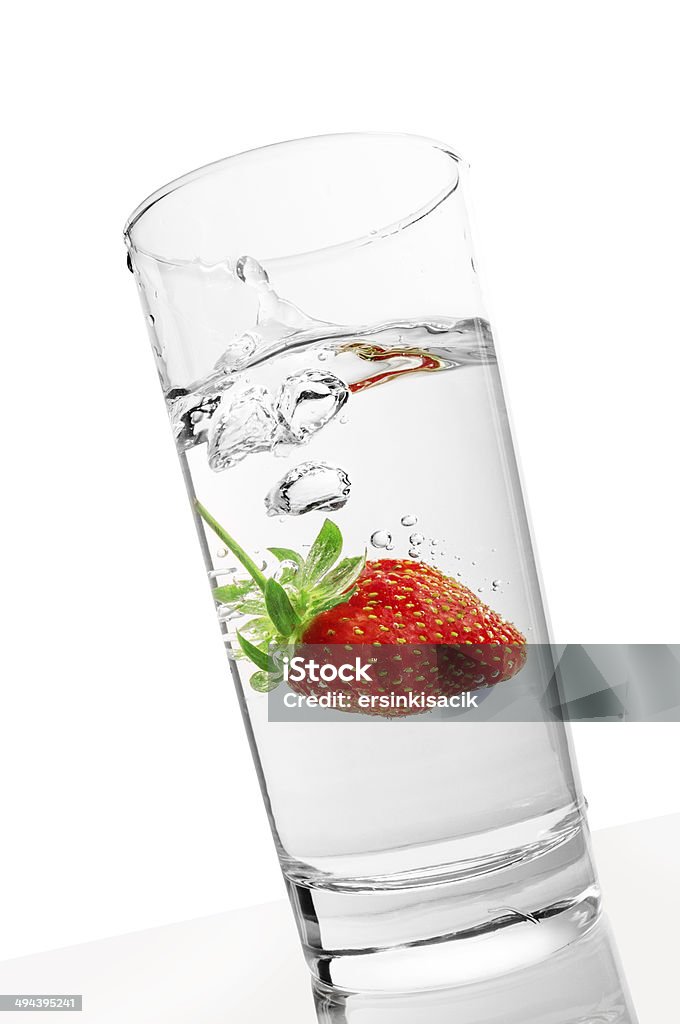 Strawberry dropped into water glass Strawberry dropped into water glass. white Background. Antioxidant Stock Photo