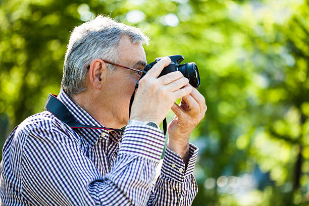 istock Senior man taking photo 494396405