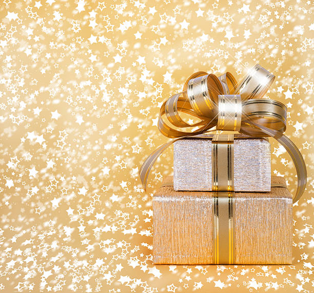 istock Gift box in gold wrapping paper on a beautiful  background 494396417