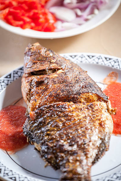 istock Baked tilapia served with red pepper sauce 494397115