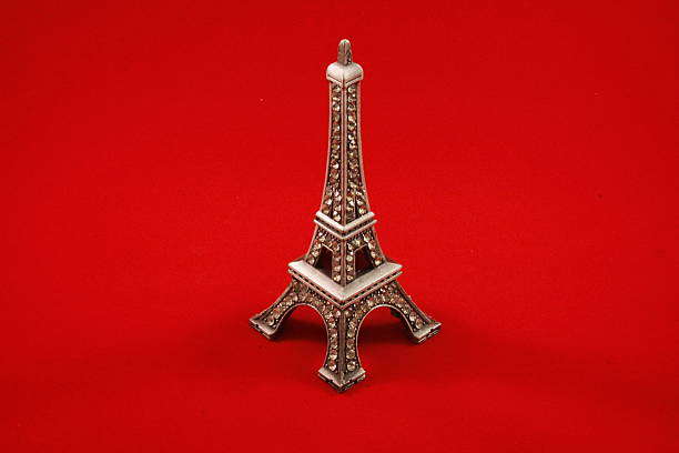 istock Miniature Eiffel Tower with rhinestones with a red background 494397609