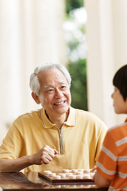 istock Grandfather and grandson playing Xiangqi (chinese chess) 494397817