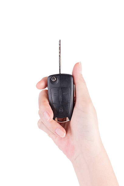 istock Hand holding a car key on white background 494398233
