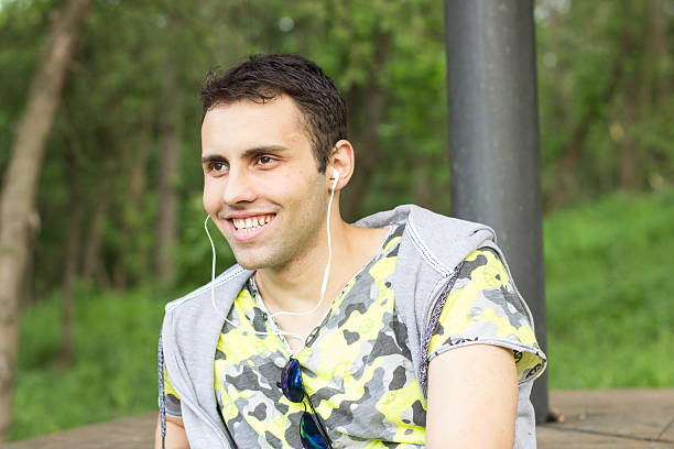 istock Young man enjoying in  park on a bench 494399953