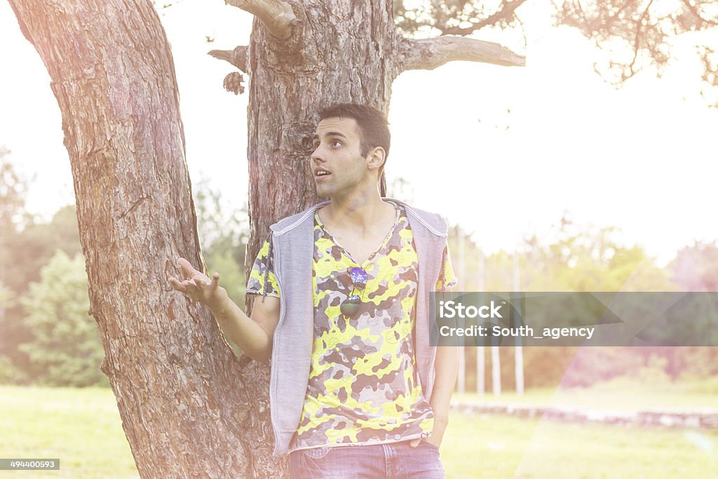 Happy young man relaxing Happy young man relaxing in the park on sunny spring day.Happy young man relaxing in the park on sunny spring day. Adult Stock Photo