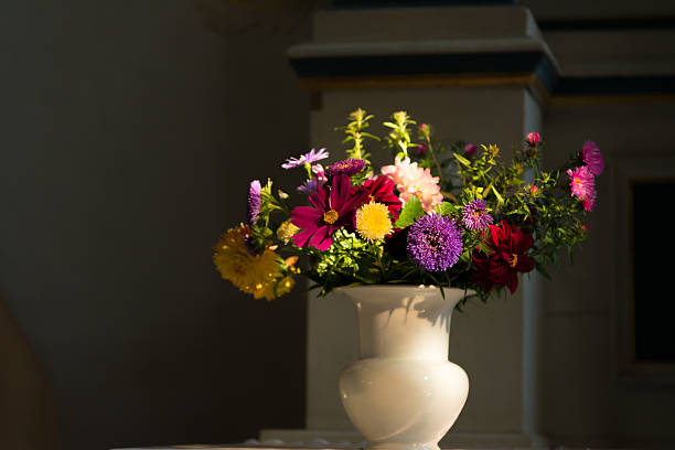 istock fall flowers at an altar in a church in light 494412330