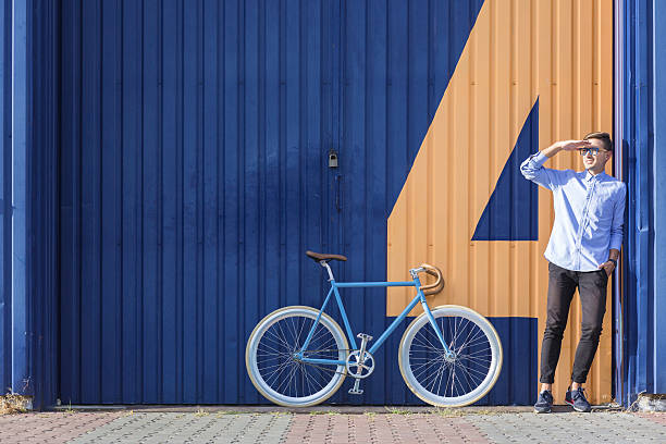 istock Businessman standing beside his bicycle 494412920