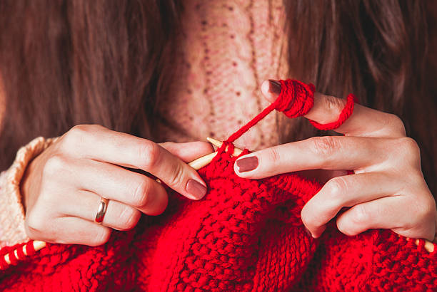 Female hands knits sweater