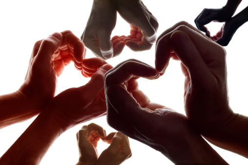 Various hands forming a symbol of love and peace.