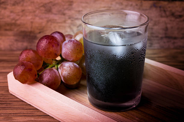 Fresh and juice grapes on wooden table