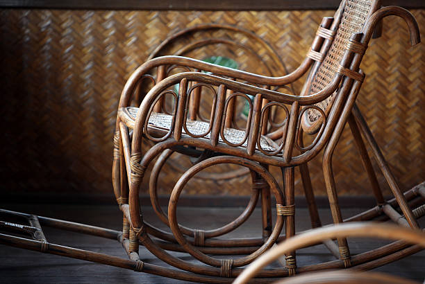A handmade wicker rocking chair sits on the floor tiles at the entrance to the home. Handmade.