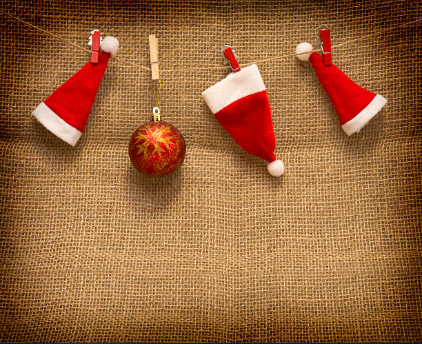 istock Christmas hats  hanging on brown cloth  background. 494417348