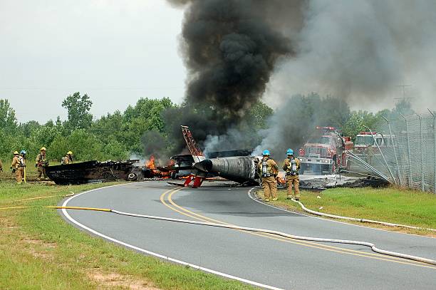 Firemen approaching F-86 plane crash at Hickory, NC airport Hickory, NC  USA- July 24, 2006: Firemen trying to extinguish the fire where an old F-86 plane crashed off the end of the runway at Hickory, NC airport airplane crash photos stock pictures, royalty-free photos & images