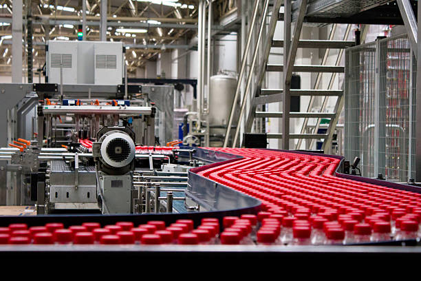 Bottles on conveyor belt in factory Bottles on conveyor belt in factory bottling plant stock pictures, royalty-free photos & images