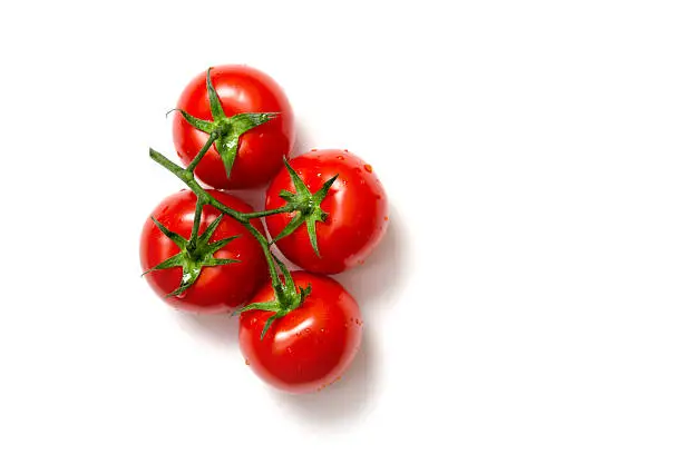 Top view of bunch of fresh tomatoes isolated on white background