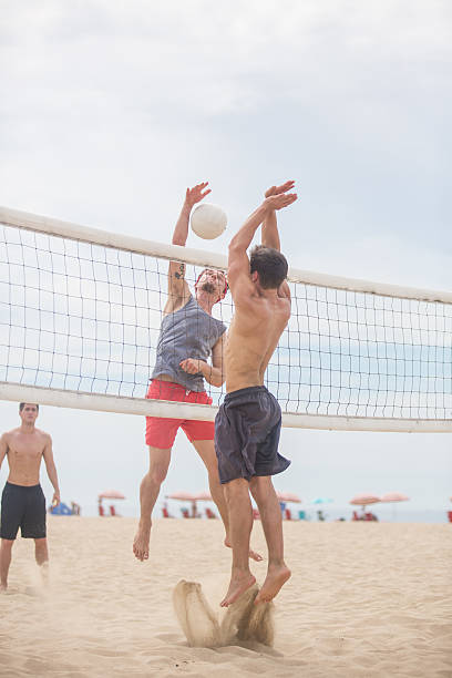istock Volleyball player spiking ball against opposing team 494419488