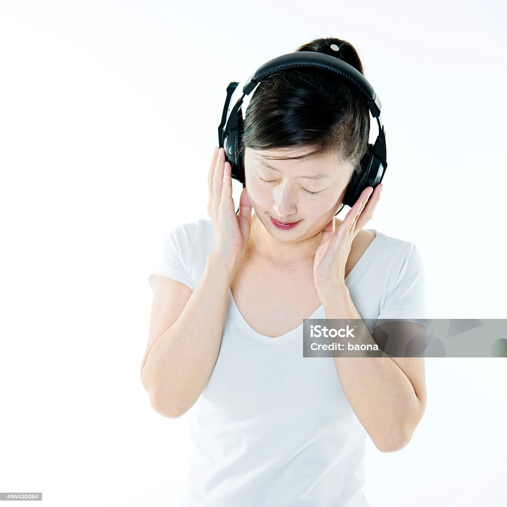 Young woman enjoying music Young woman enjoying music, isolated on white background. Headphones Stock Photo